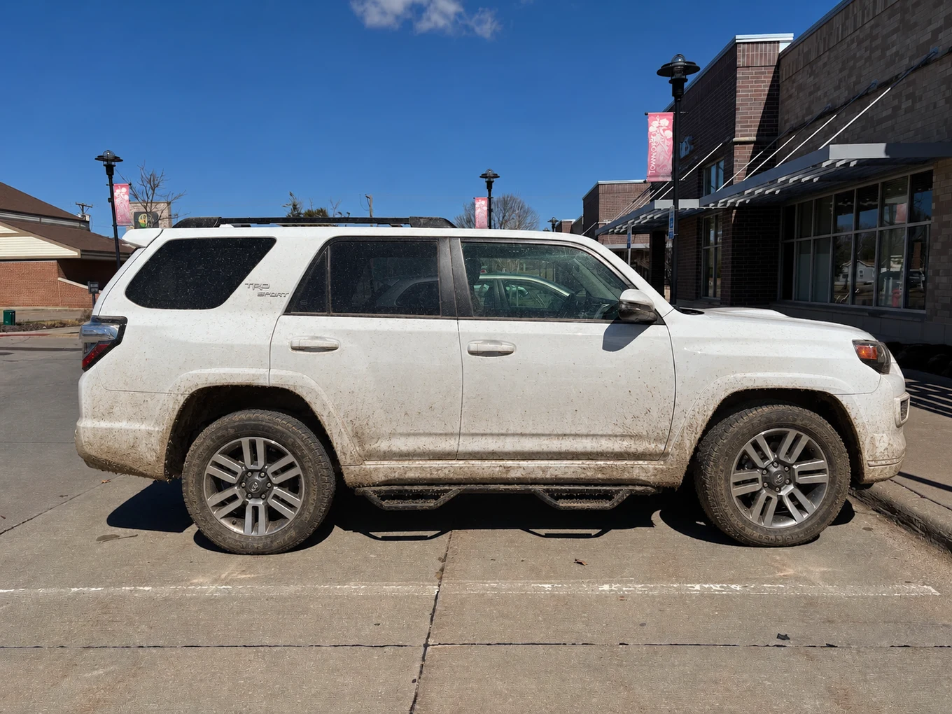 Illustrative muddy condition preview of a white Toyota SUV